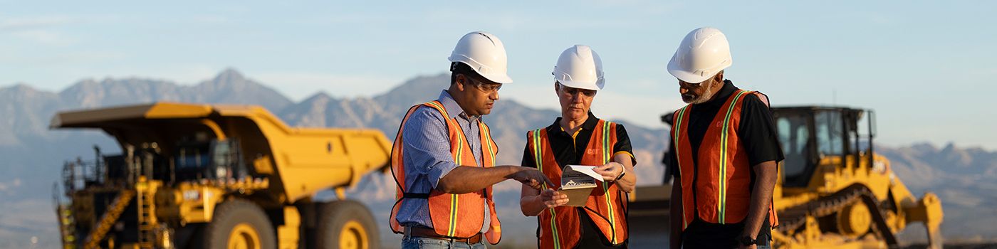 operators standing in front of a mining truck