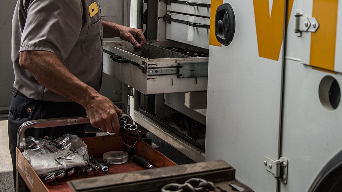 a Cat service truck with the tool cabinet open