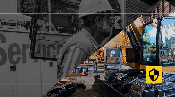 A Cat excavator working on a construction site with a Cat Certified Maintained badge overlay as part of a CVA. 