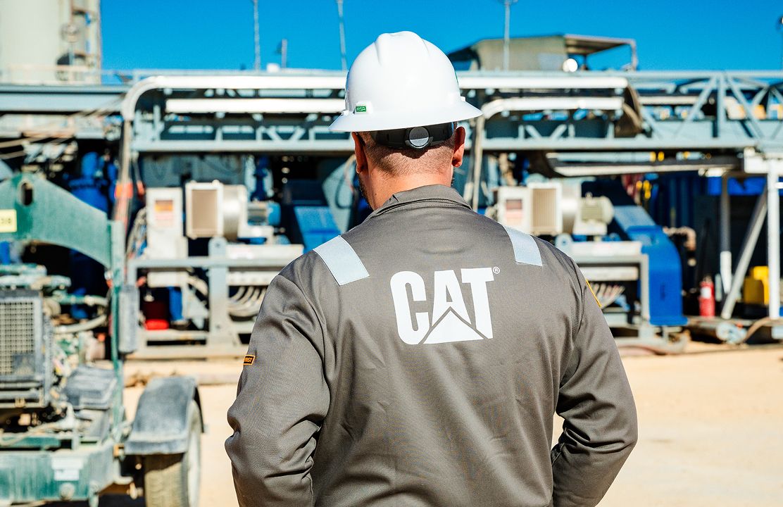 Back of a Cat employee overlooking a site