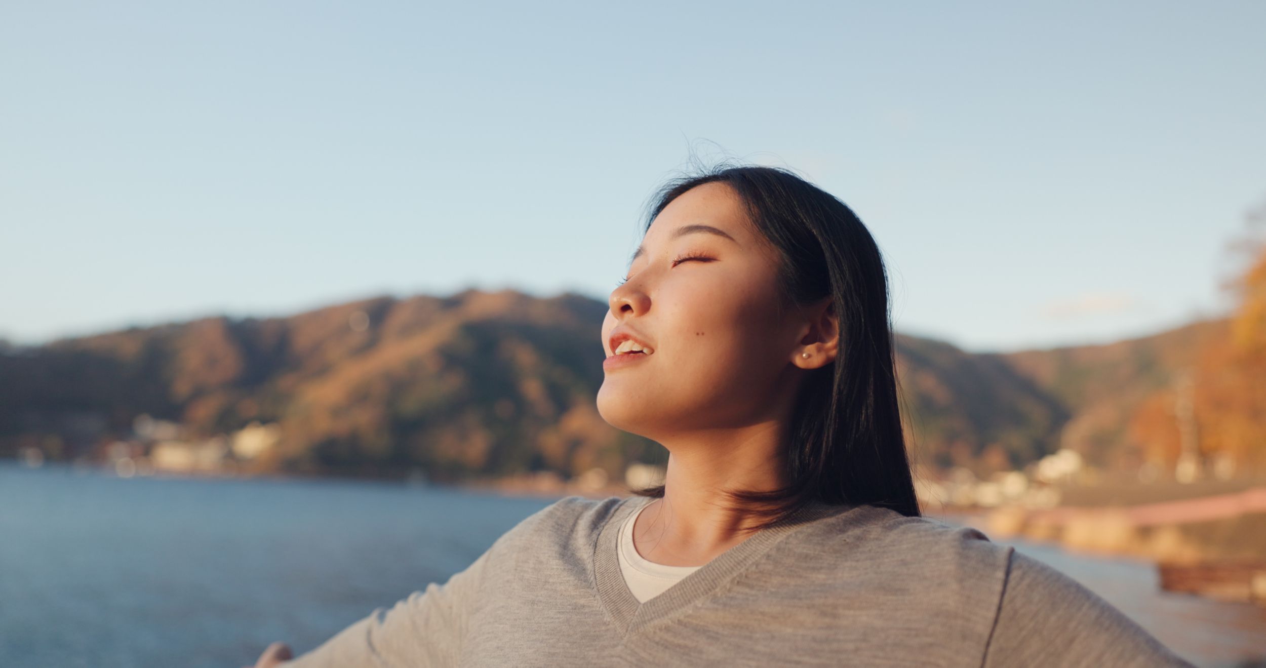 Woman taking a mindful breath amongst nature