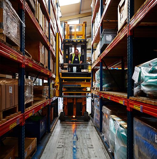 Stocking warehouse shelves with a forklift