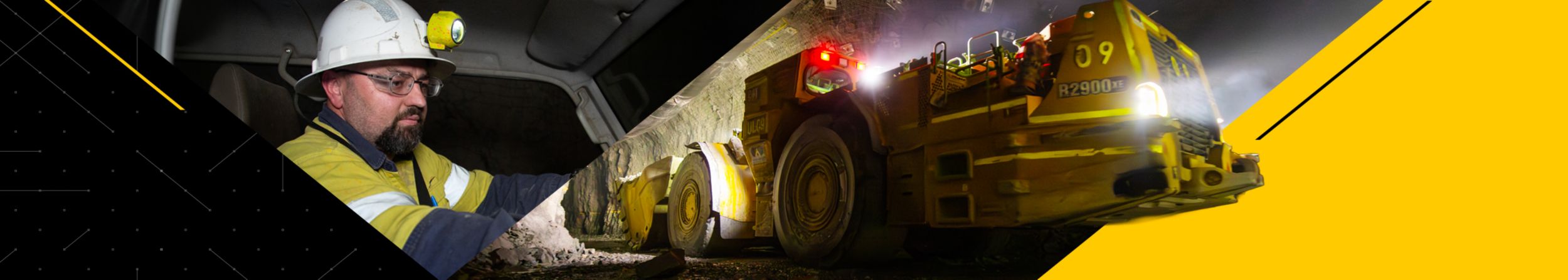 Two men near machinery in an underground mine