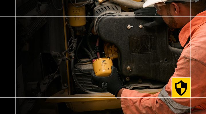 Cat engine oil filter replacement and self-service maintenance on heavy equipment. Ideal for commercial engine maintenance, genuine Cat parts installation, and scheduled equipment servicing. 