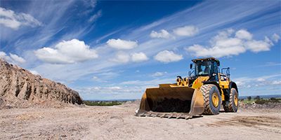 Man standing in front of CAT equipment