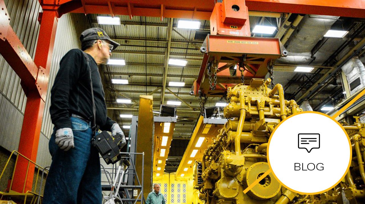 Worker inspecting a Cat G3600 A4 Gen 2 upgrade on an engine