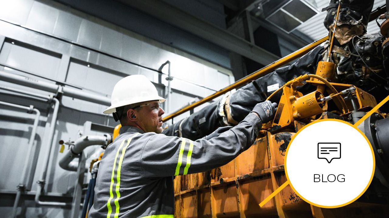 Worker in a hardhat performing maintenance on a closed crankcase ventilation (CCV) engine