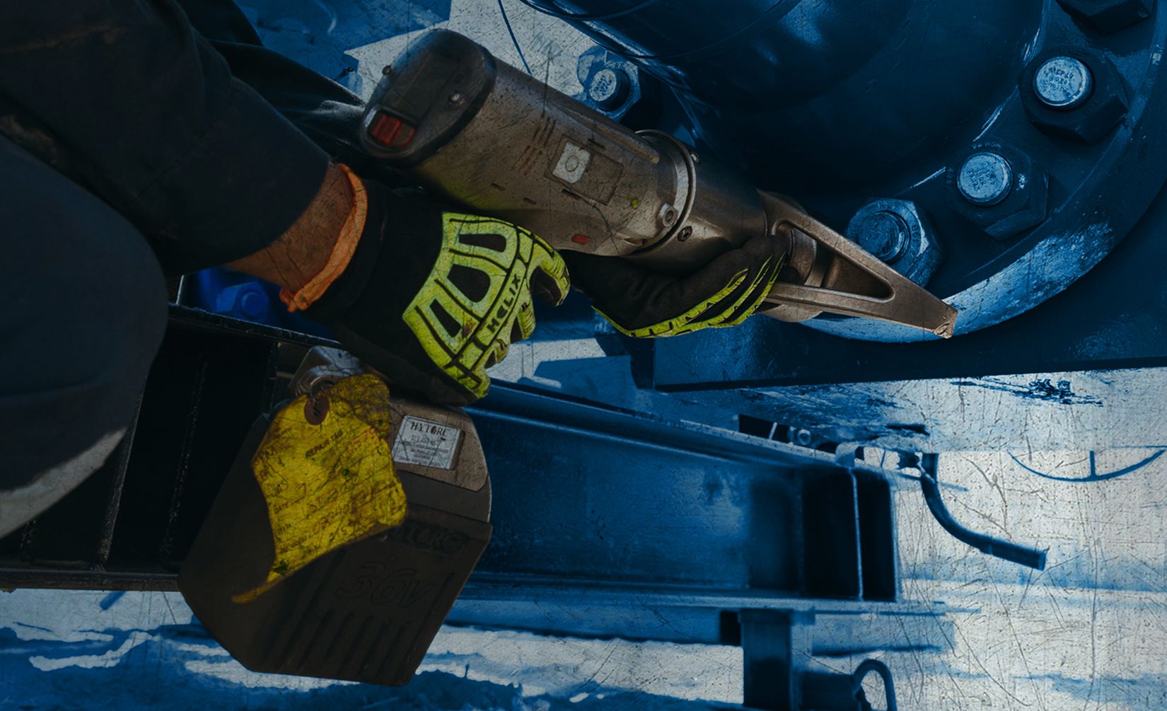 Close up of a worker's gloved hands using equipment
