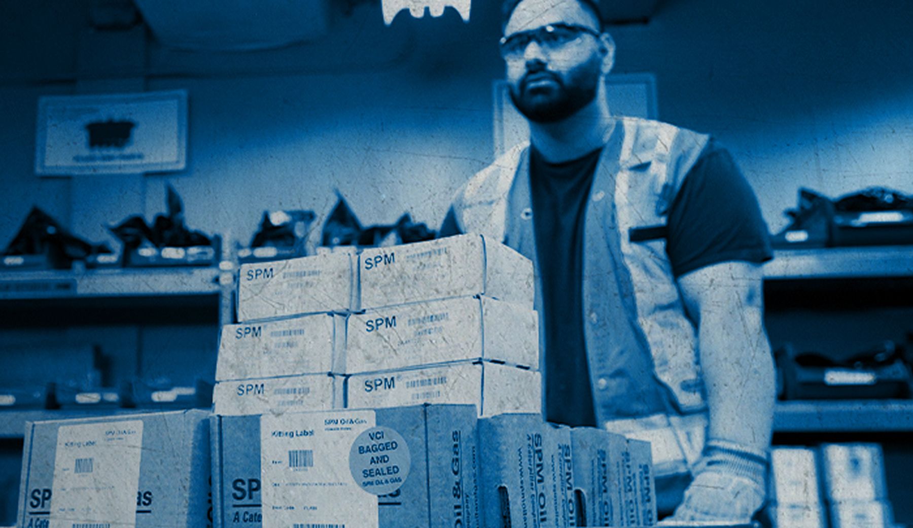 An employee pushing a cart through a stockroom