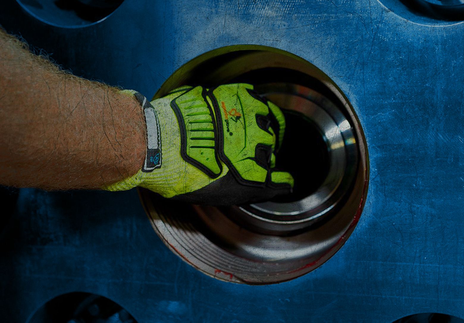 A close up of a worker's gloved hand
