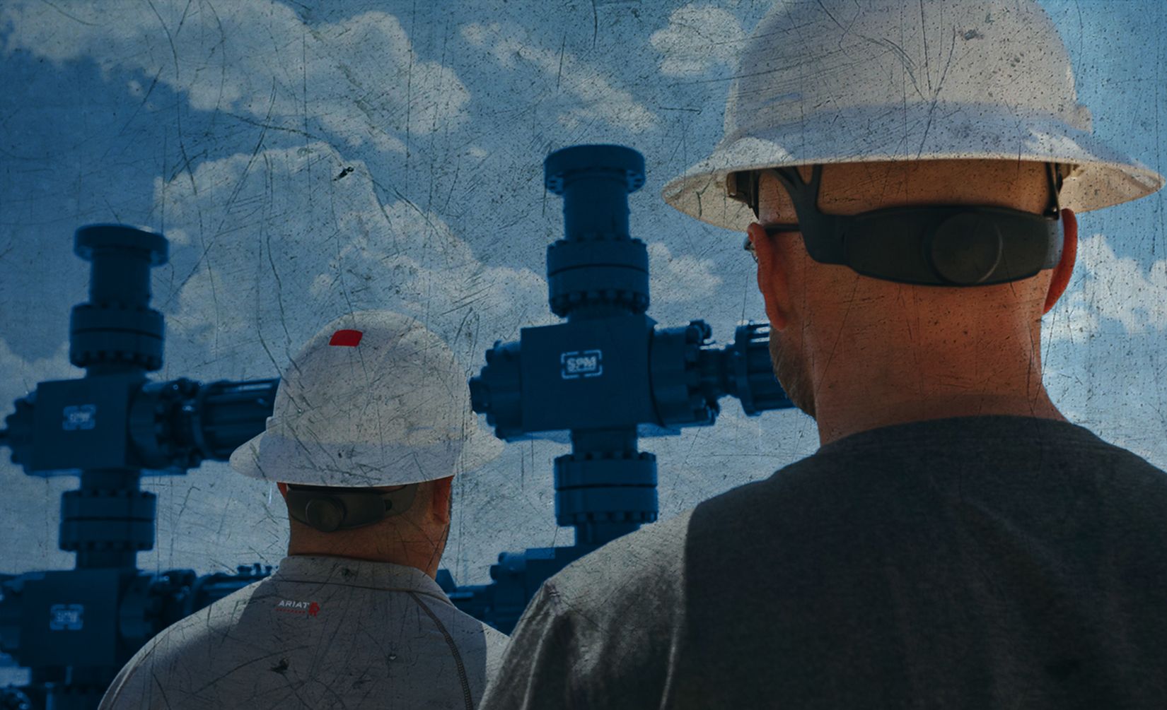 Two workers on site walking away from the camera