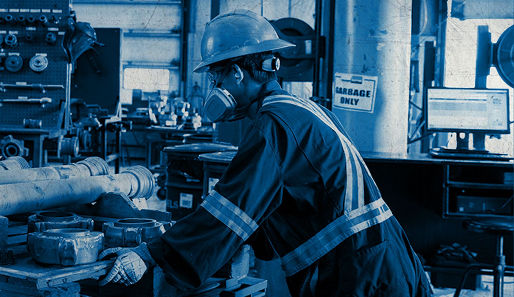 A worker pushes a cart with parts