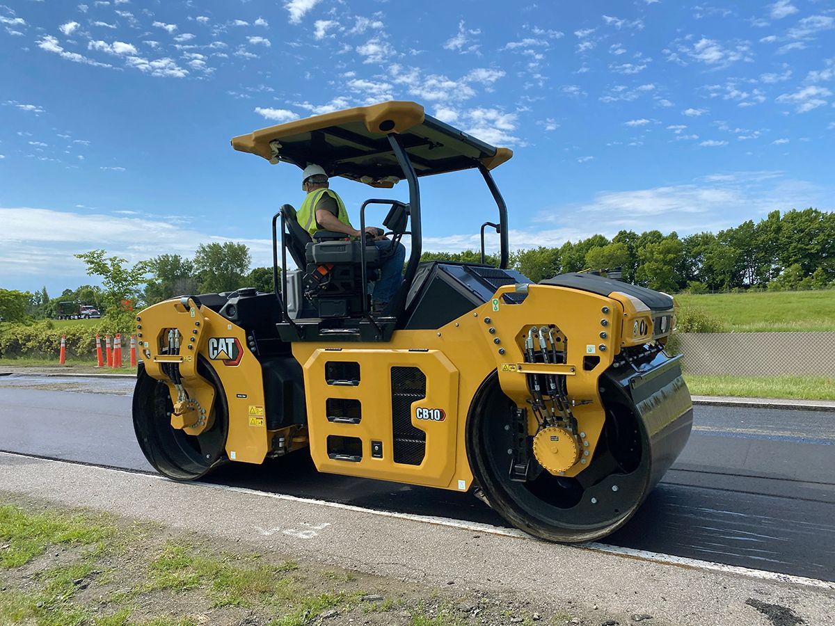 Cat® CB10 asphalt roller compacting asphalt.