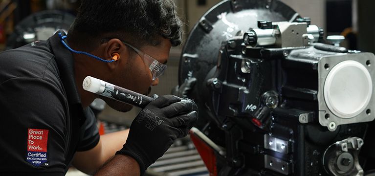 technician examining a transmission