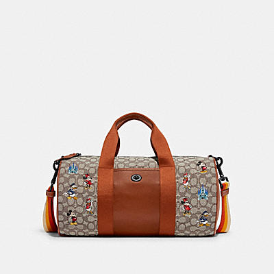 DISNEY X COACH DUFFLE IN SIGNATURE TEXTILE JACQUARD WITH MICKEY MOUSE AND FRIENDS EMBROIDERY