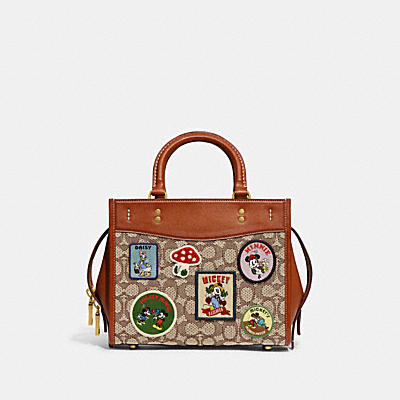 DISNEY X COACH ROGUE 25 IN SIGNATURE TEXTILE JACQUARD WITH PATCHES