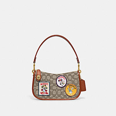 DISNEY X COACH SWINGER 20 IN SIGNATURE TEXTILE JACQUARD WITH PATCHES
