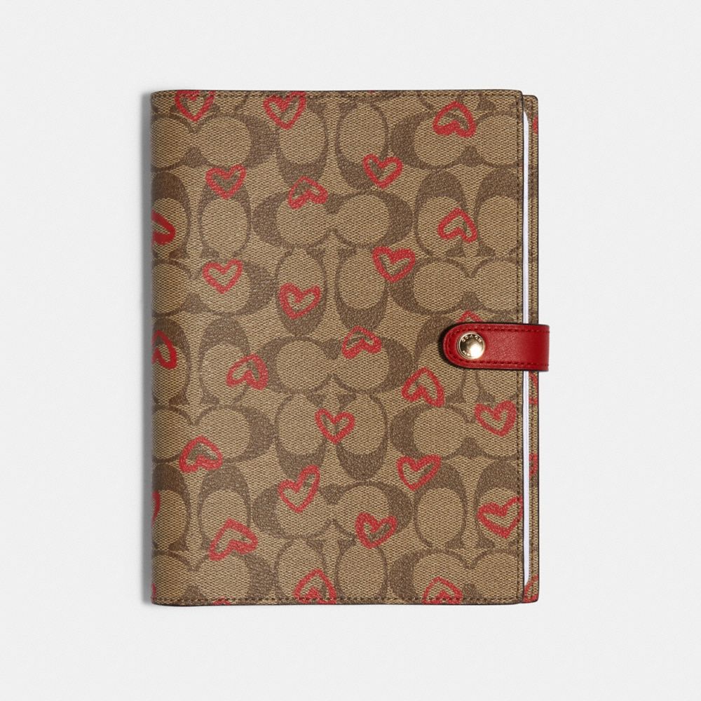 COACH NOTEBOOK IN SIGNATURE CANVAS WITH CRAYON HEARTS PRINT - KHAKI/RED - 89982