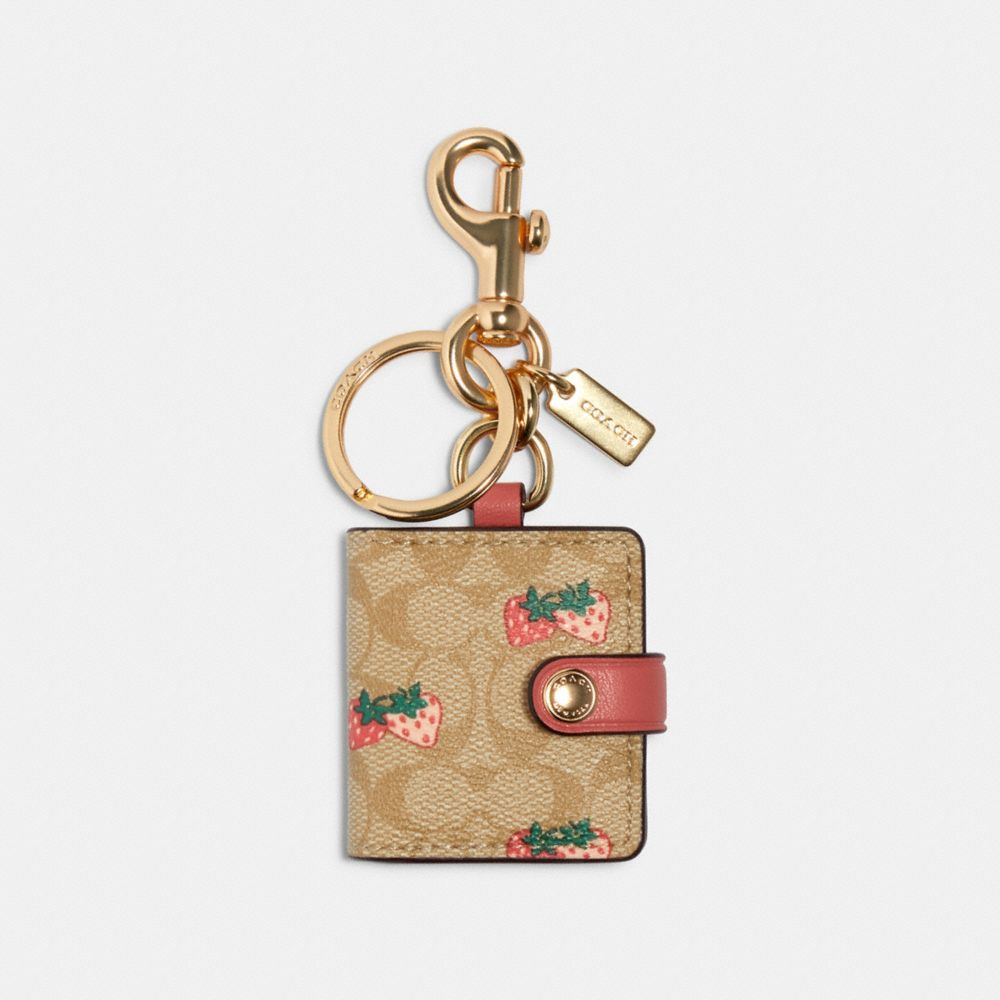 COACH 89998 PICTURE FRAME BAG CHARM IN SIGNATURE CANVAS WITH STRAWBERRY PRINT IM/LIGHT KHAKI/CORAL