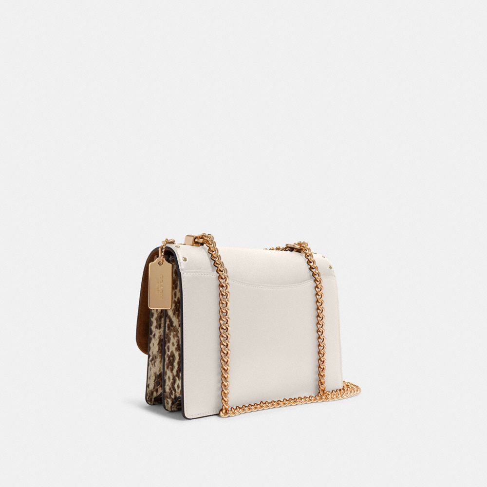 KLARE CROSSBODY IN SIGNATURE CANVAS WITH RIVETS