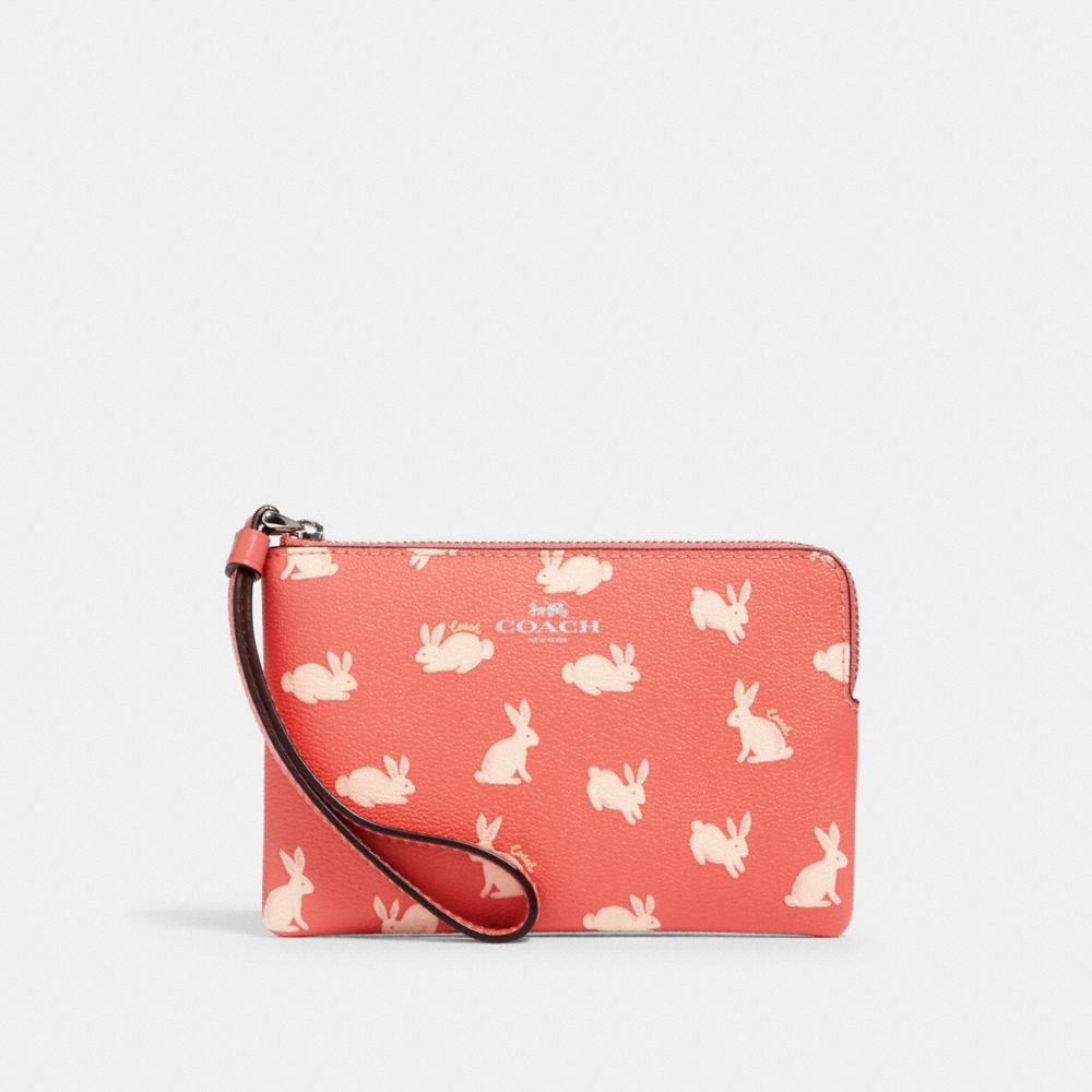 COACH 93053 CORNER ZIP WRISTLET WITH BUNNY SCRIPT PRINT SV/BRIGHT CORAL