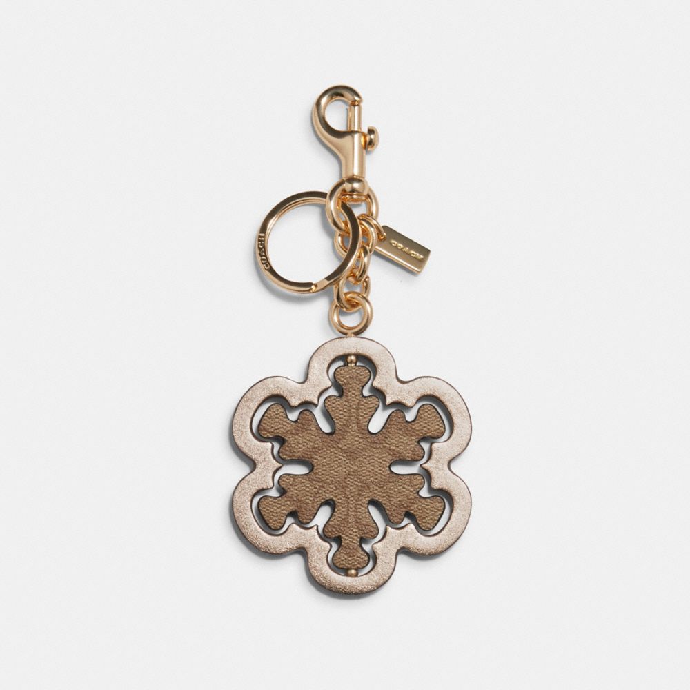 COACH SPINNING SNOWFLAKE BAG CHARM IN SIGNATURE CANVAS - IM/BROWN/METALLIC PALE GOLD - C1754