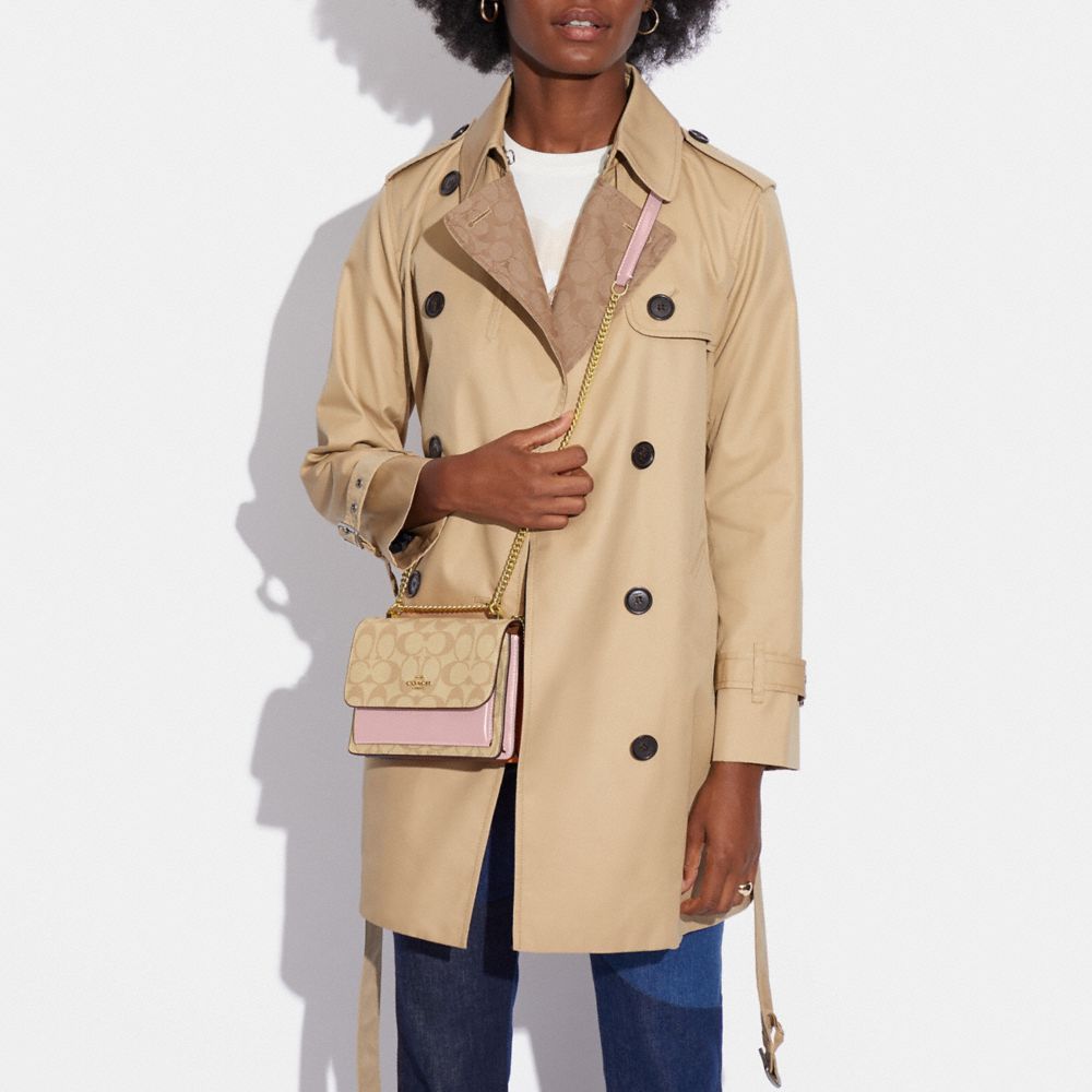 MINI KLARE CROSSBODY IN SIGNATURE CANVAS