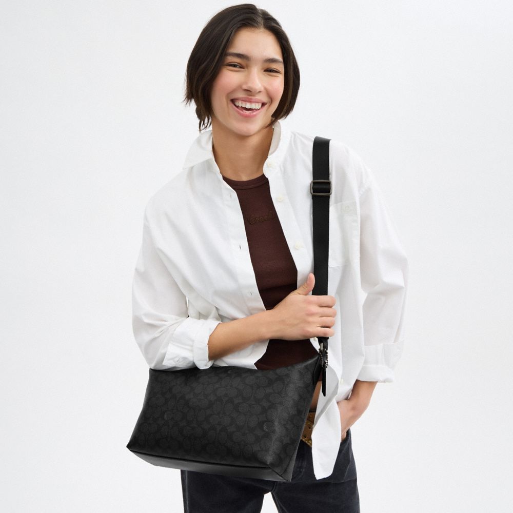 FINN CROSSBODY BAG IN SIGNATURE CANVAS