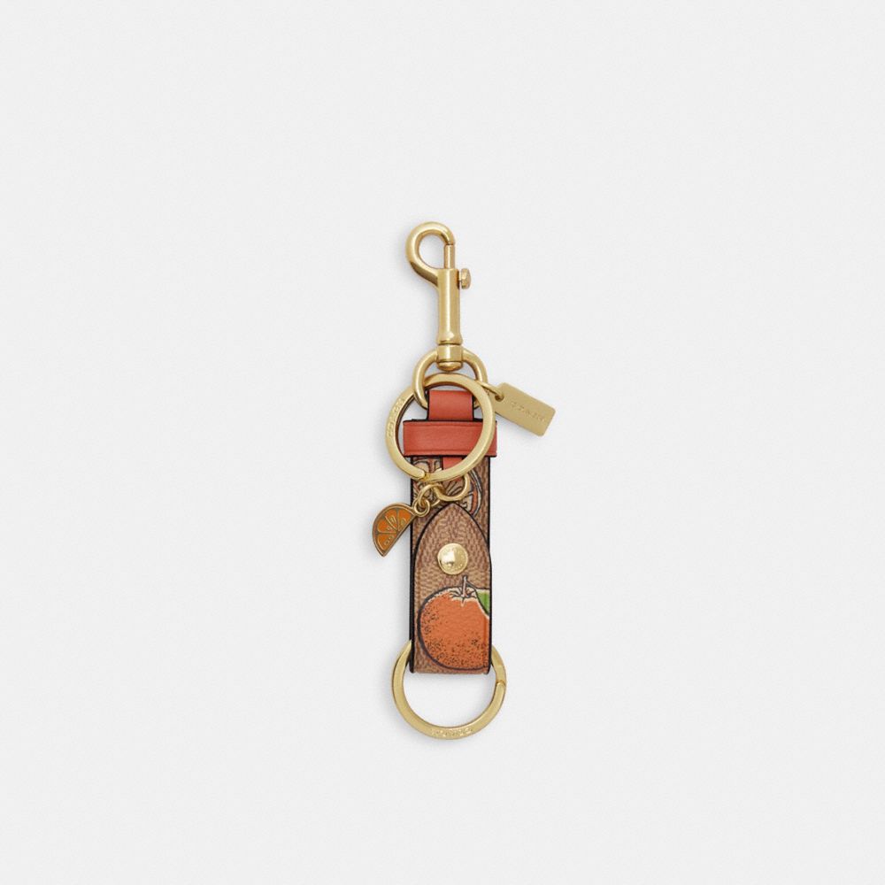 COACH CAO46 Trigger Snap Bag Charm In Signature Canvas With Orange Print GOLD/TAN MULTI