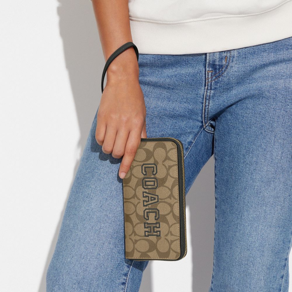 LONG ZIP AROUND WALLET IN SIGNATURE CANVAS WITH VARSITY MOTIF