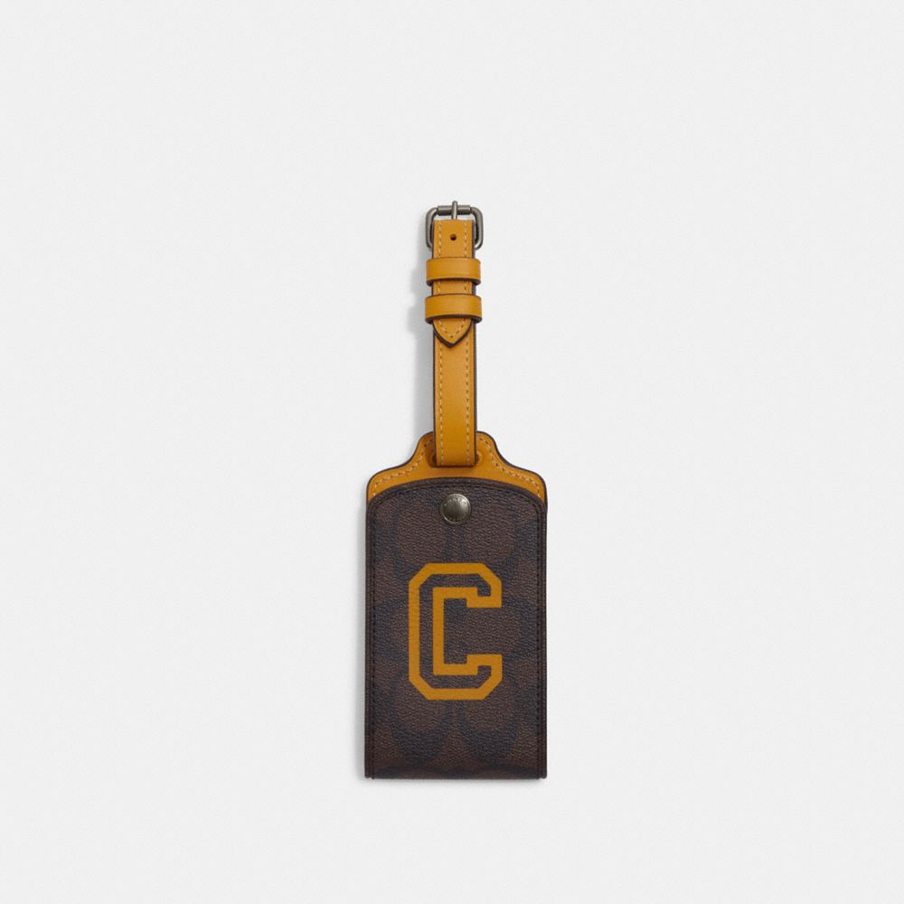 COACH CB921 Luggage Tag In Signature Canvas With Varsity Motif QB/Mahogany/Buttercup