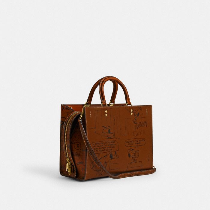 COACH X PEANUTS NEWSPAPER PRINT ROGUE BAG