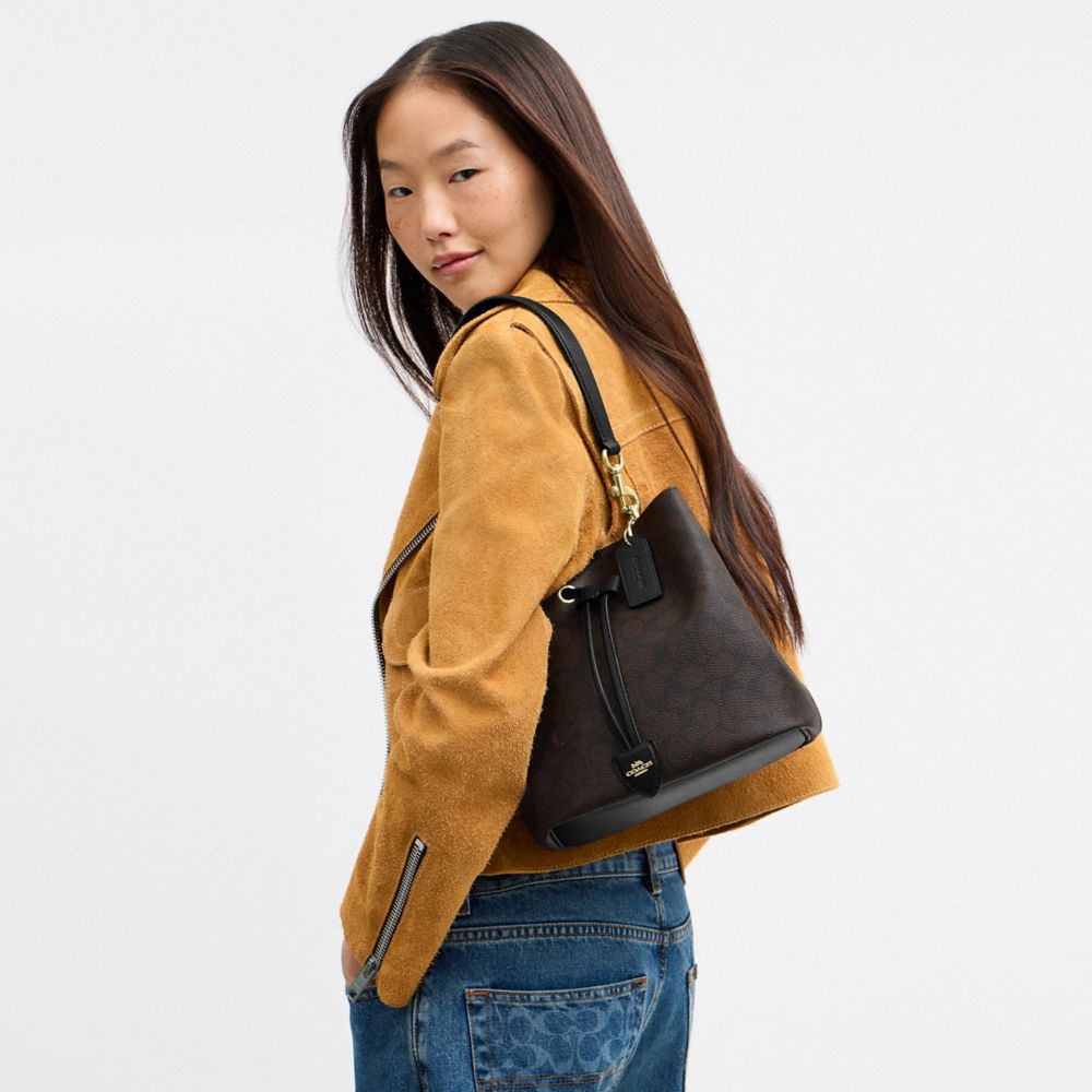 ROWAN BUCKET BAG IN SIGNATURE CANVAS