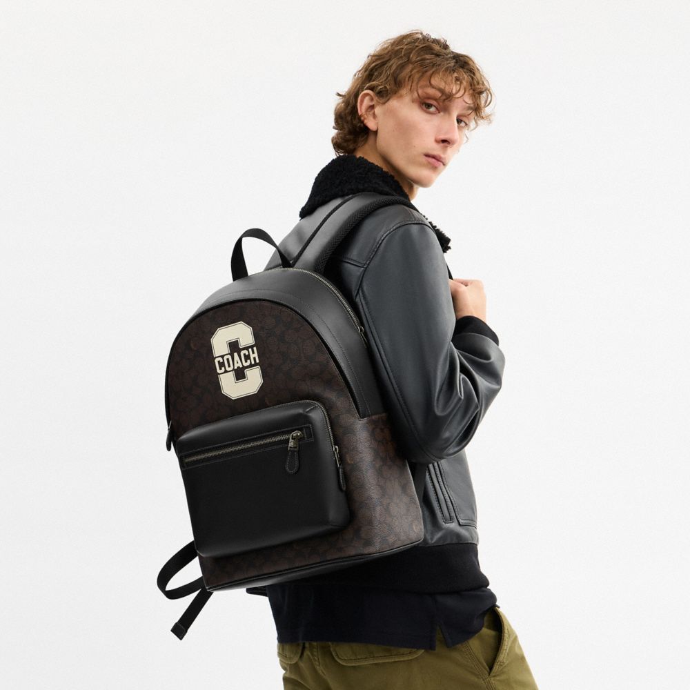 WEST BACKPACK IN SIGNATURE CANVAS WITH VARSITY GRAPHIC