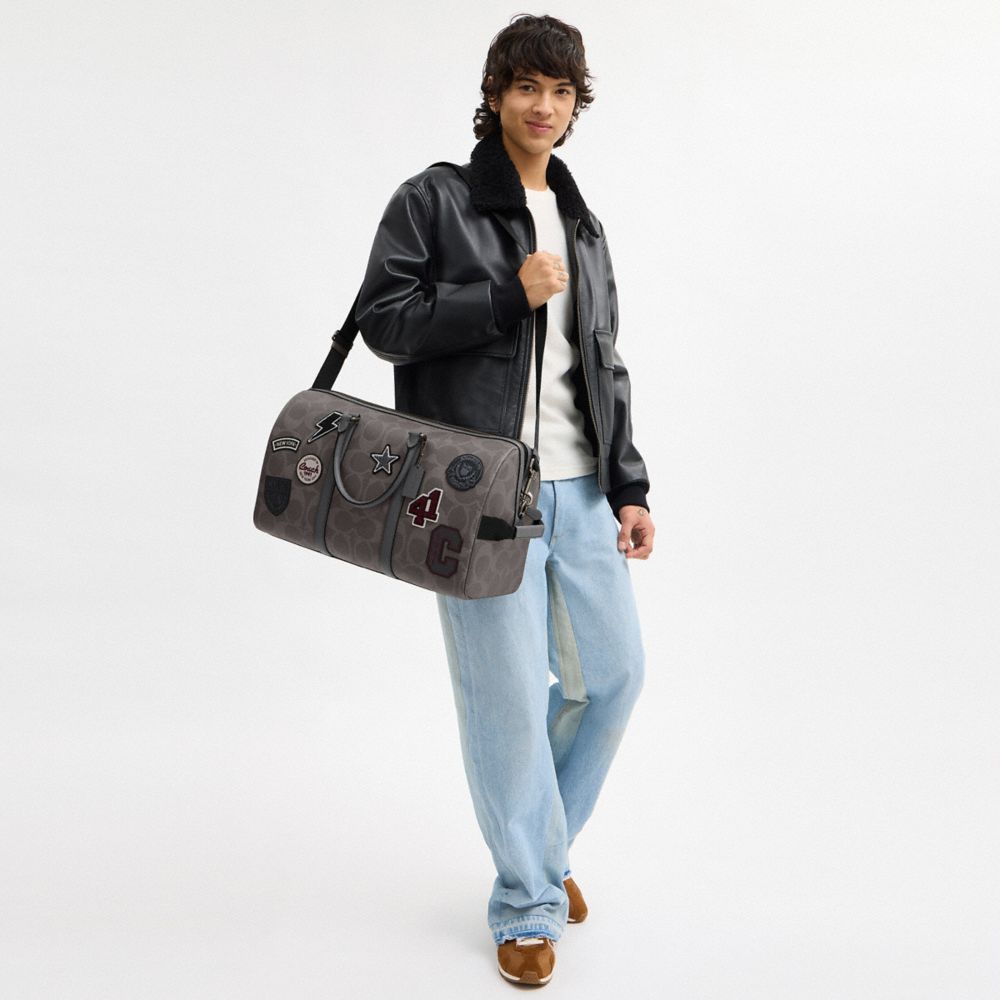 VENTURER BAG IN MAXI SIGNATURE CANVAS WITH PATCHES