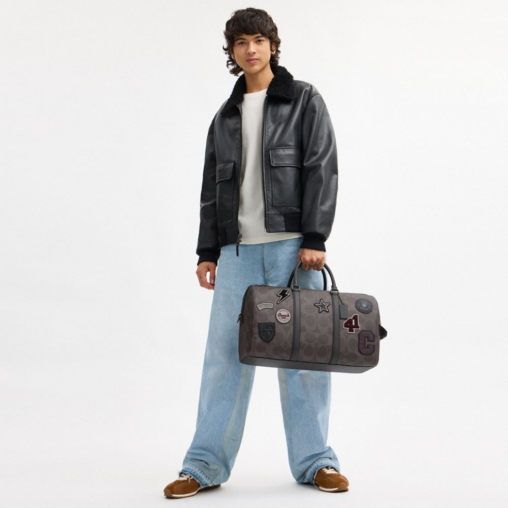 VENTURER BAG IN MAXI SIGNATURE CANVAS WITH PATCHES