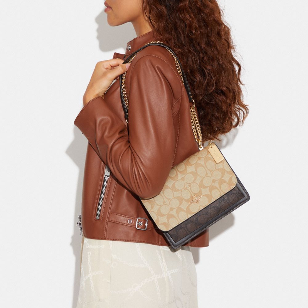 KLARE CROSSBODY IN BLOCKED SIGNATURE CANVAS