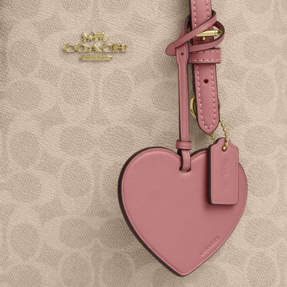 MOLLIE TOTE BAG 25 IN SIGNATURE CANVAS WITH HEART CHARM