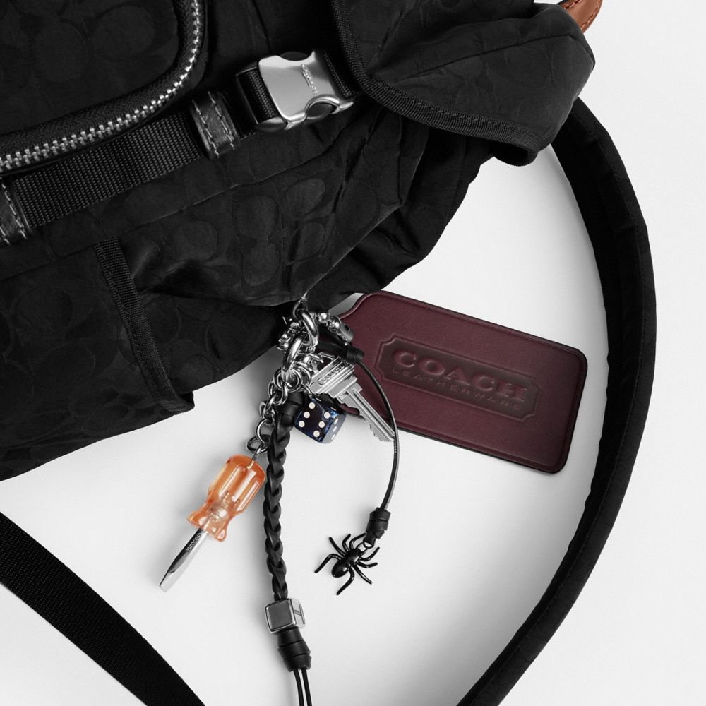 LOGAN BACKPACK IN SIGNATURE NYLON WITH CHARMS