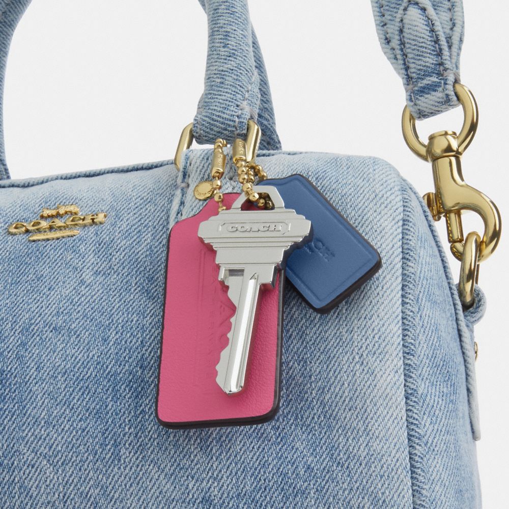 MINI ROWAN CROSSBODY BAG IN LOVED DENIM WITH CHARMS