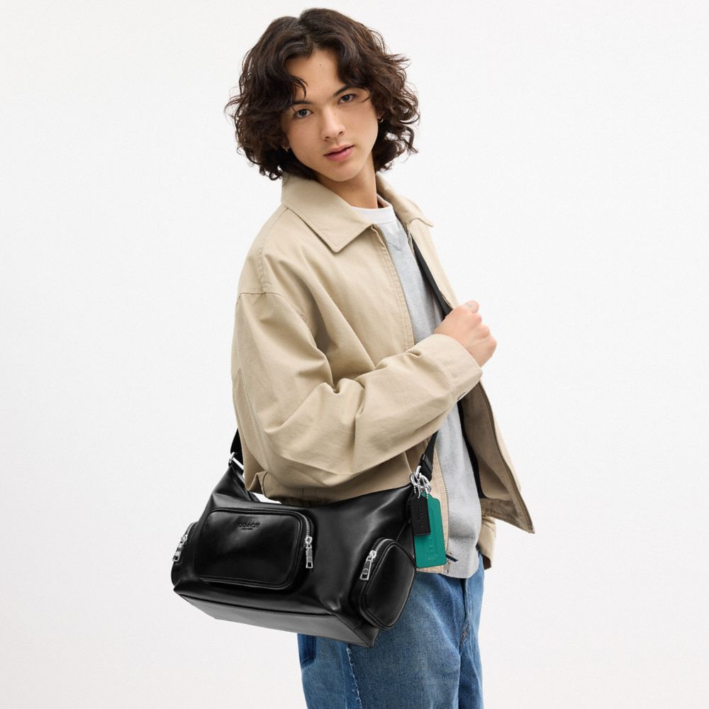 FINN CROSSBODY BAG WITH POCKETS AND CHARMS