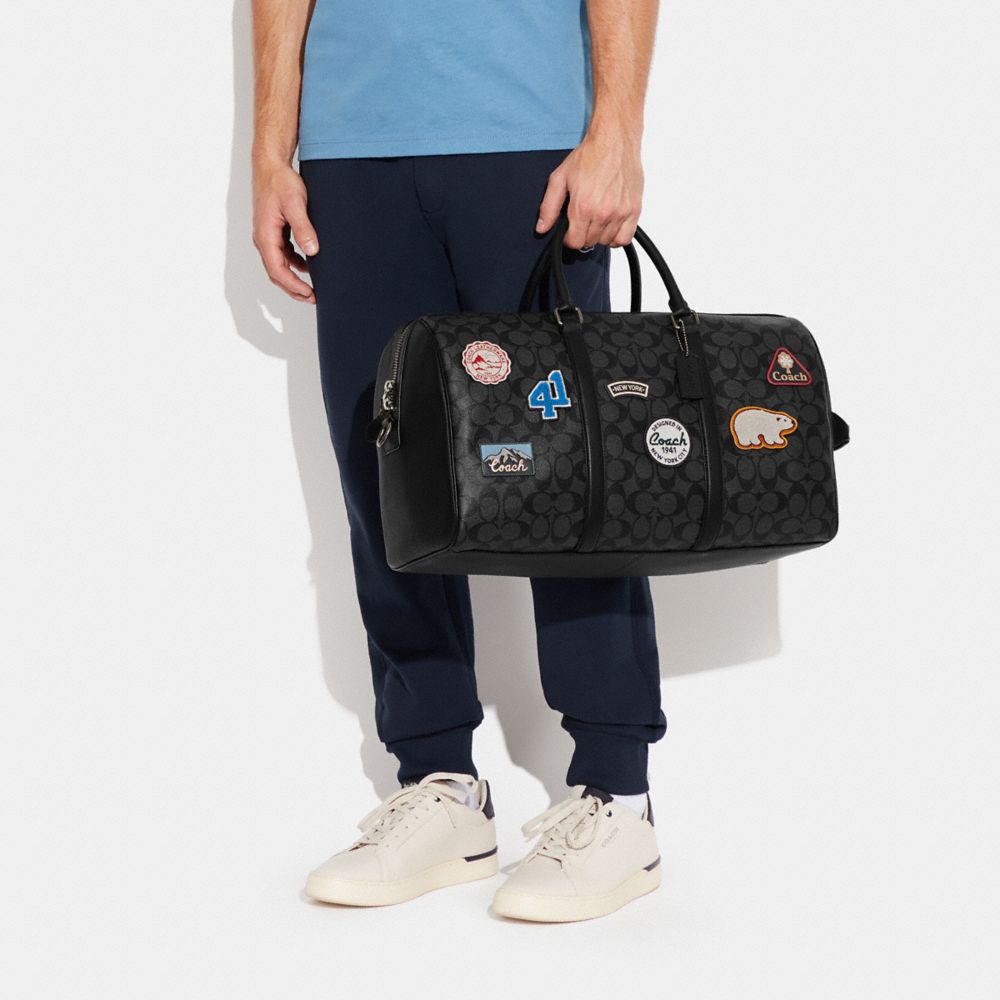 VENTURER BAG IN SIGNATURE CANVAS WITH SKI PATCHES