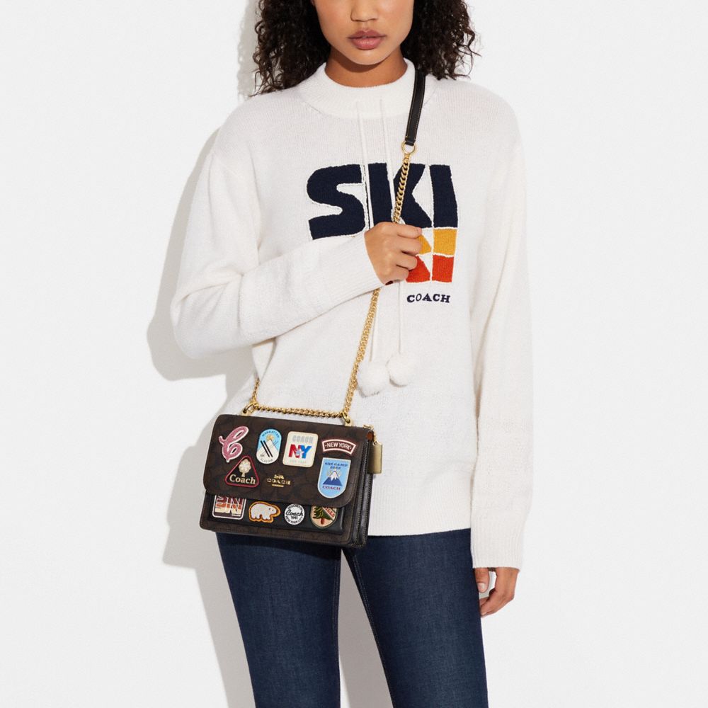 KLARE CROSSBODY IN SIGNATURE CANVAS WITH SKI PATCHES