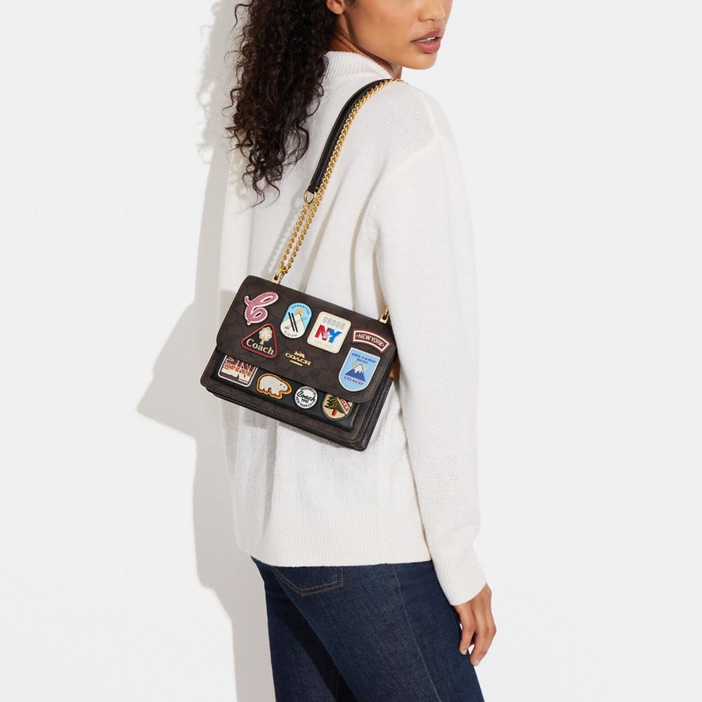 KLARE CROSSBODY IN SIGNATURE CANVAS WITH SKI PATCHES