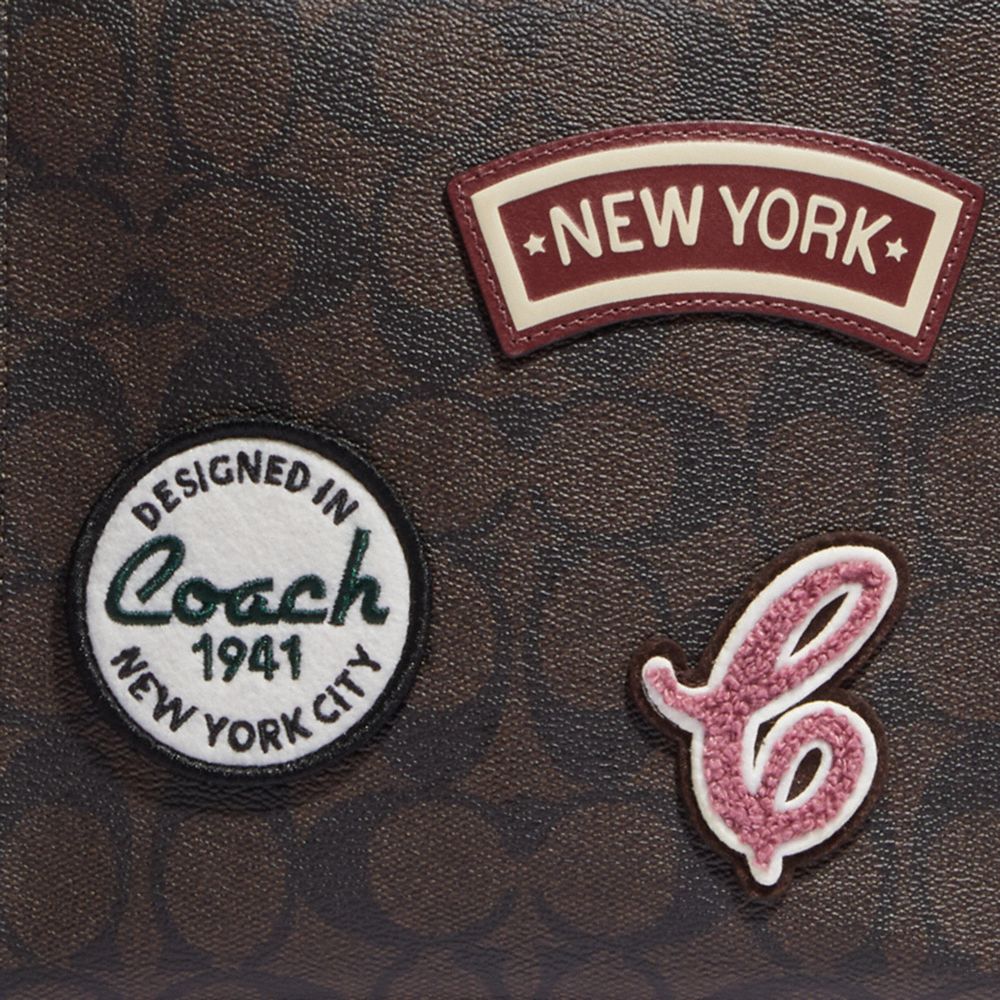 MINI CALLY CROSSBODY IN SIGNATURE CANVAS WITH SKI PATCHES