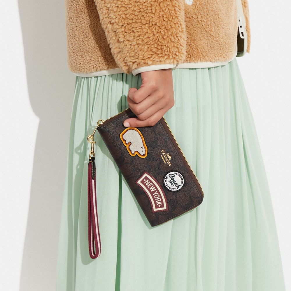 LONG ZIP AROUND WALLET IN SIGNATURE CANVAS WITH SKI PATCHES