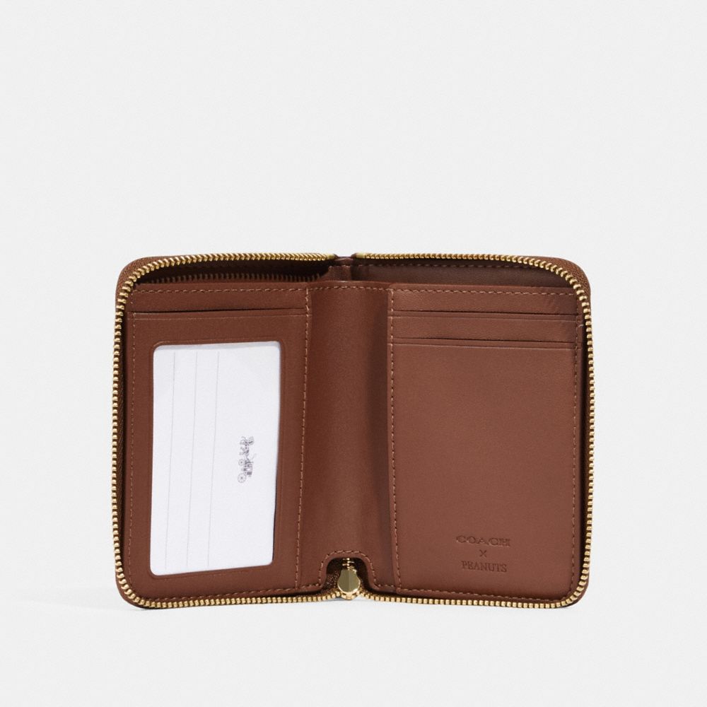 COACH X PEANUTS SMALL ZIP AROUND WALLET IN SIGNATURE CANVAS WITH SNOOPY WOODSTOCK PRINT