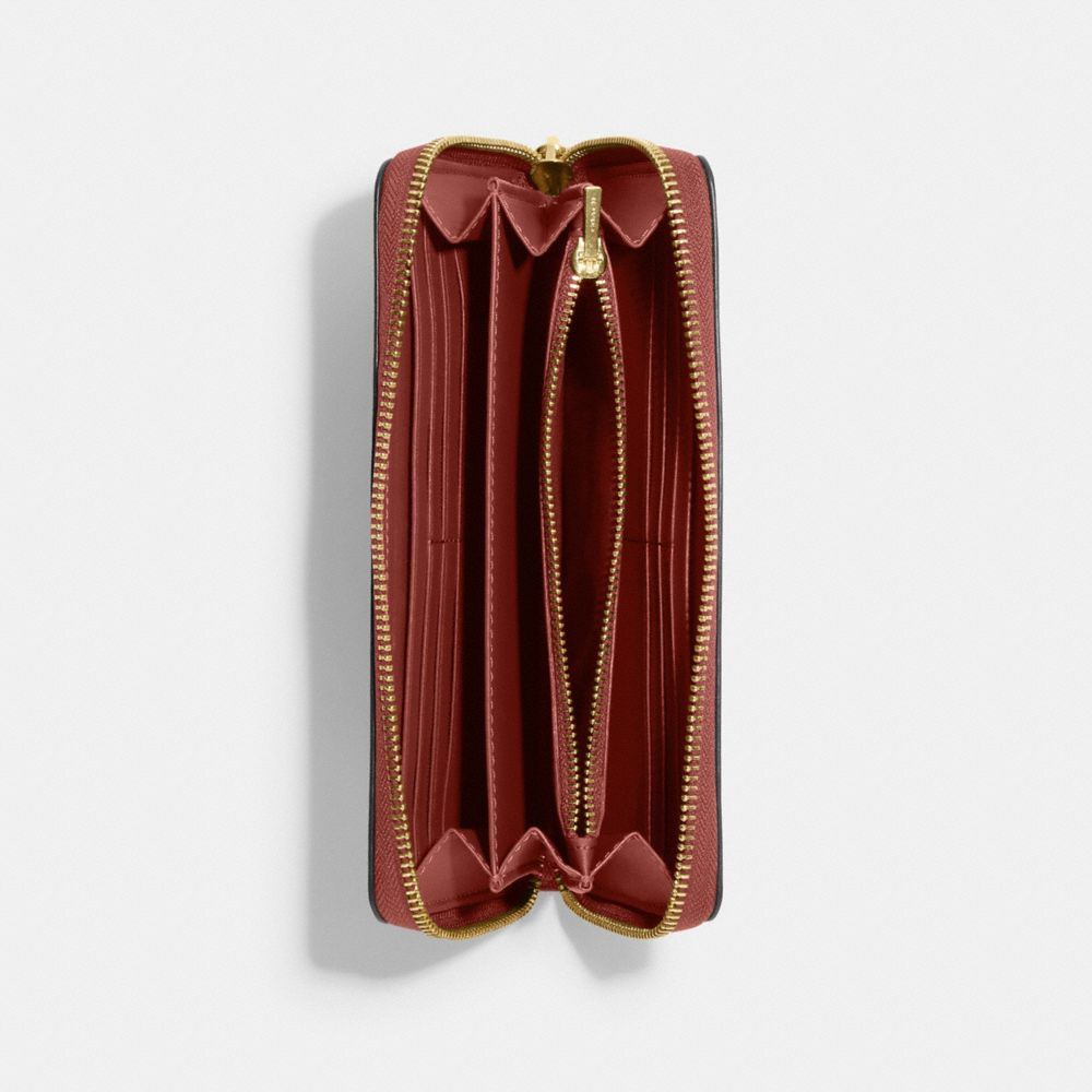 COACH X PEANUTS LONG ZIP AROUND WALLET IN SIGNATURE CANVAS WITH SNOOPY WOODSTOCK PRINT