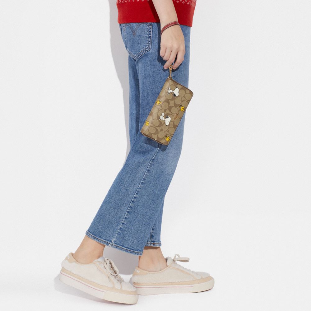 COACH X PEANUTS LONG ZIP AROUND WALLET IN SIGNATURE CANVAS WITH SNOOPY WOODSTOCK PRINT