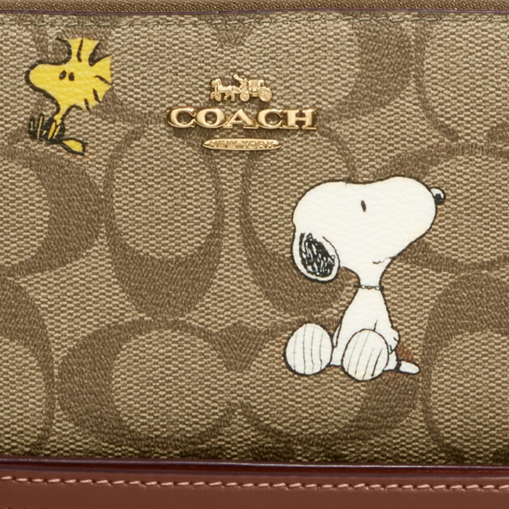 COACH X PEANUTS LONG ZIP AROUND WALLET IN SIGNATURE CANVAS WITH SNOOPY WOODSTOCK PRINT
